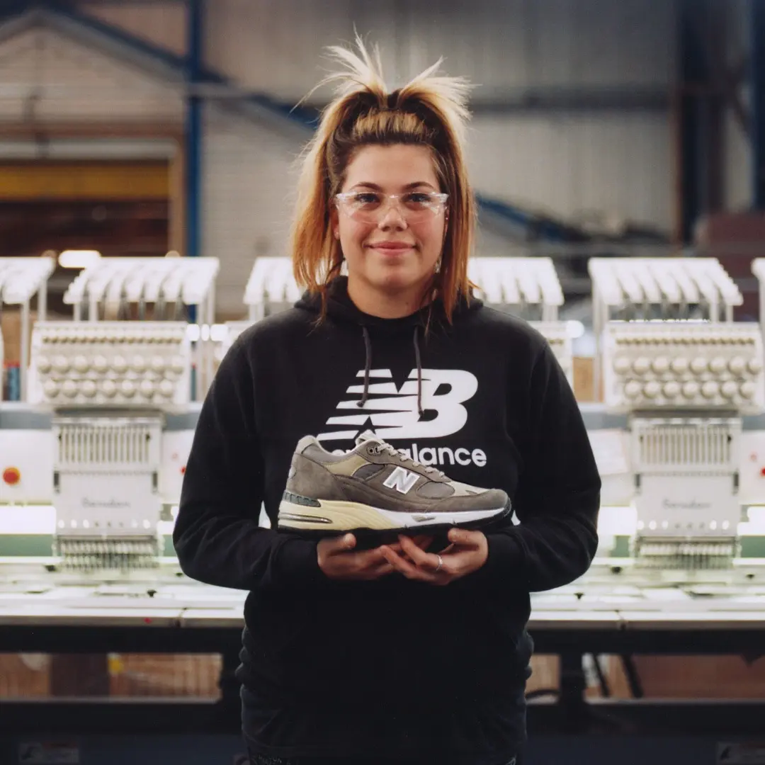 holding new balance shoe